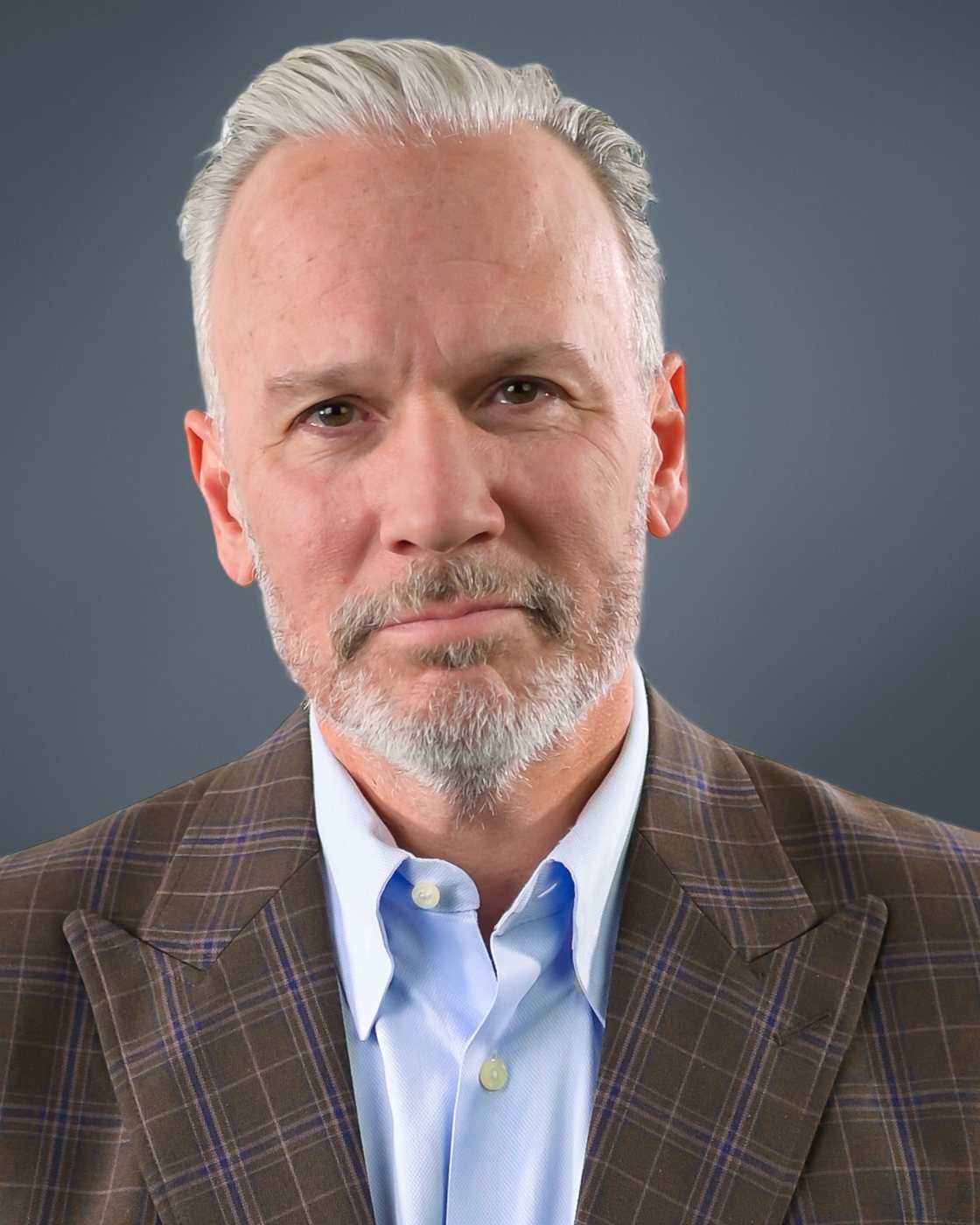 Glenn Fisher, studio portrait in a brown plaid sport coat